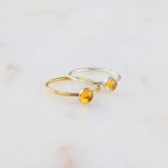 Radiate warmth and positivity with our stunning citrine ring. Crafted to capture the golden hues of the sun, this ring showcases the vibrant beauty of citrine gemstones. Perfect for adding a touch of brightness to your ensemble, or as a symbol of joy and abundance in your life. Don't know your ring size? Ring Size Guide or Buy Ring Sizer …………………………………. Details: Stone Citrine measuring 5mm Available in 14k Gold Filled or Sterling Silver Waterproof and can be worn everyday Size Inclusive and made