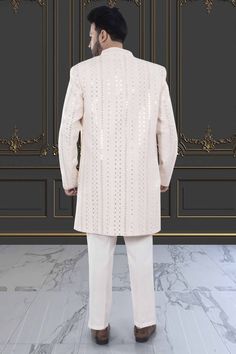 This Mens Sherwani (M42-S133) is an open jacket style with exquisite sequin and thread embroidery. The intricate detailing adds a touch of elegance to this traditional attire. Perfect for weddings and special occasions, this sherwani is a must-have for anyone looking to make a statement. Mens Sherwani, Open Jacket, Traditional Attire, Thread Embroidery, Jacket Style, Must Haves, Sequin, Thread, Weddings