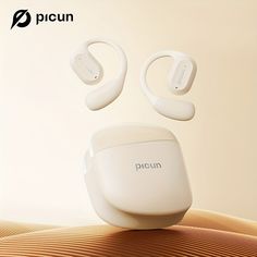 an electronic device with two ear buds attached to it's back end, sitting on top of a beige surface