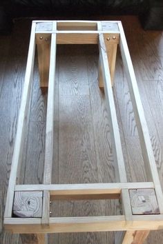 a wooden table sitting on top of a hard wood floor