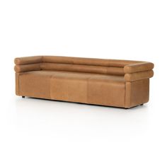 a brown leather couch sitting on top of a white floor