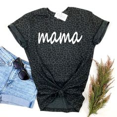 The coolest black leopard print tee! Choose from Mama or Mini or add both for a matching Mommy & Me set! Choose your Design (Mama or Mini), then Size, then Add to Cart. Repeat these steps for each shirt you would like to add. Professionally screen printed. Shirt color is Black Leopard. Print color is White. Mama is printed on a standard adult unisex tee made of 60% ringspun cotton/40% polyester. Fits true to size. Unisex sizing. We recommend ordering the same size you normally wear in an adult u Leopard Print T-shirt With Letter Print And Crew Neck, Trendy Cotton T-shirt In Leopard Print, Casual Leopard Print Crew Neck T-shirt, Trendy Leopard Print Graphic T-shirt, Leopard Print Graphic Crew Neck Top, Summer Cotton Leopard Print Tops, Trendy Leopard Print Cotton Tops, Trendy Leopard Print T-shirt For Spring, Casual Cotton T-shirt In Leopard Print