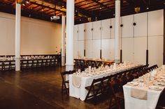 a large room with tables and chairs set up for a formal dinner or banquet event