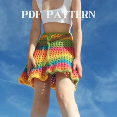 a woman in a white top and multicolored crochet skirt