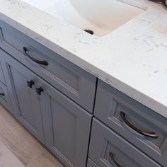 a bathroom vanity with marble counter top and white sink