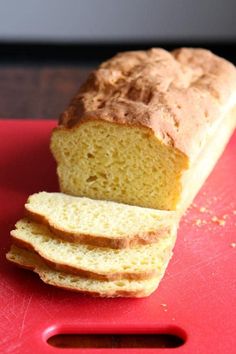 a loaf of bread sitting on top of a red cutting board