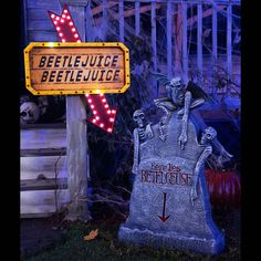 a sign that is next to a grave with skeletons on it and an arrow pointing towards beetlejuice