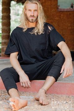 "This basic relaxed fit mens organic top looks like a simple t-shirt, but has a little designer detail - handmade ripped decorative stripe on the side, which transforms it into one of a kind piece. It pairs perfectly with our Linen pants or any ethnic trousers, but also can be worn with jeans as a part of your casual outfit. We have chosen a classic black color for this model that matches with most of the other Chintamani Alchemistry palette. Loose silhouette and 100% natural fabric makes this p Relaxed Fit Short Sleeve Alternative T-shirt, Short Sleeve T-shirt For Alternative Summer Fashion, Short Sleeve T-shirt For Alternative Fashion In Summer, Summer Short Sleeve T-shirt For Alternative Fashion, Relaxed Fit Short Sleeve Tops For Festival, Alternative Style Relaxed Fit Cotton Tops, Alternative Style Cotton Tops With Relaxed Fit, Casual Cotton Tops For Alternative Fashion, Alternative Style Cotton Tops For Summer