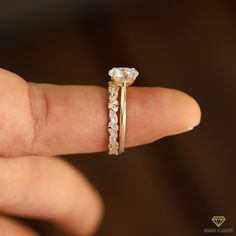 a close up of a person's hand with a ring on their finger and diamond band