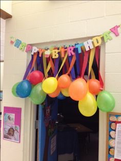 an image of a birthday party with balloons and streamers on the front door,