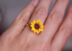 Sunflower ring women -Yellow flower gold plated ring - Summer floral jewelry women Dia of flower about 18 mm/ 0,7 inches Adjustable floral ring with clay sunflower. The ring is adjustable and can fit size 6.5-8.5 by gently pushing together the ends, overlapping them or gently pulling them apart. Material of flower - polymer clay. Each petal made by hand without using any mold Material of flower -polymer clay. Polymer clay isn't afraid of water, strong, flexible but this delicate flower may break Yellow Flower Shaped Jewelry For Anniversary, Yellow Flower-shaped Jewelry For Anniversary, Yellow Flower Jewelry For Anniversary, Yellow Flower Ring For Anniversary, Handmade Yellow Gold Flower Ring, Yellow Flower Ring For Wedding, Gold Polymer Clay Jewelry For Wedding, Gold Polymer Clay Wedding Jewelry, Adjustable Yellow Rings For Gift