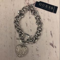 Nwt Guess Heart Charm Chain Bracelet. Silver-Tone Chain Bracelet. Pav Rhinestone Heart Charm And Engraved Logo Detail At Closure. 8” Length ½” Width Toggle Closure Guess Jewelry, Charm Chain, Rhinestone Heart, Engraved Logo, Bracelet Silver, Heart Bracelet, Womens Jewelry Bracelets, Heart Charm, Chain Bracelet