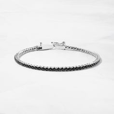 Dainty and minimalist black tennis bracelet is a stunning accessory! Looks great stacked or on its own! Made of 925 Sterling Silver We use a THICK plating of 14k Gold or Rhodium Available in 6.25" or 6.75" Lengths Latch closure for a super high end look! 2mm Width Nickel-free & Hypoallergenic Black Jubilee Tennis Bracelet For Gift, Black Jubilee Tennis Bracelet Gift, Classic Black Chain Bracelet For Everyday, Adjustable Black Tennis Bracelet As Gift, Adjustable Black Tennis Bracelet For Gift, Classic Black Diamond Tennis Bracelet, Adjustable Black Tennis Bracelet For Formal Occasions, Recycled Metal, Tennis Bracelet