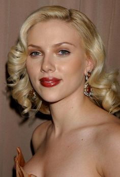 a woman with blonde hair and red lipstick