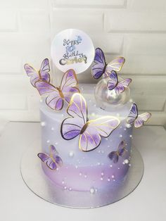 there is a cake with purple butterflies on it