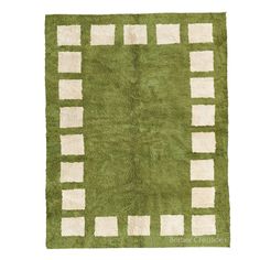 a green rug with white squares on it