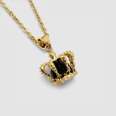 Your kingdom. Your rules. A solid onyx stone sits encased within an intricate 18K Gold crown, marking it as one of our most detailed and must-have pendants to date. This piece boasts ultra-durable, scratch-resistant plating and hangs regally upon a 3mm Gold Link Chain - a true standout of the King's Collection. For a seamless look, effortlessly stack it alongside the 18K Gold Crown Band Ring and any Gold Bracelet of your choice. Included: Full Lifetime Warranty ✓ 18K Gold & 316L Stainless Steel✓ Regal Gold Jewelry For Formal Occasion, Regal Gold Necklace For Gift, Gold Onyx Pendant Jewelry, Regal Gold Jewelry With Crown Design, Regal Gold Jewelry Gift, Gold Onyx Round Pendant Jewelry, Royal Gold Jewelry For Formal Occasions, Luxury Gold Jewelry With Crown Design, Luxury Crown Design Gold Jewelry