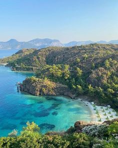 an aerial view of the blue water and beach