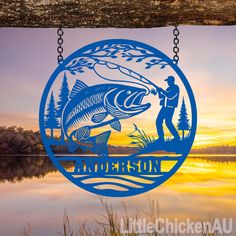 a man fishing on the lake with a fish hanging from it's side at sunset