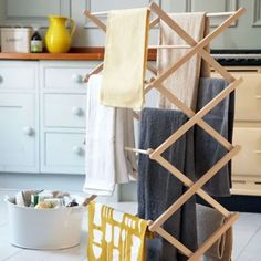 towels are hanging on clothes racks in the kitchen