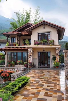 a large house with lots of windows and plants on the front porch, surrounded by greenery