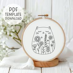 an embroidery pattern with a cat on it