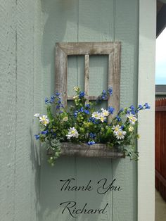 a wooden window box with flowers in it and the words thank you richard written below