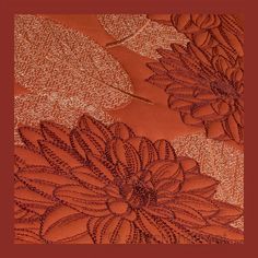 an orange and red background with flowers on it