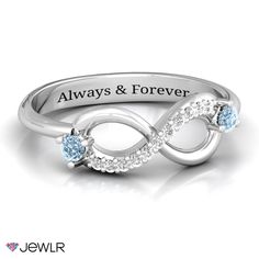 a white gold ring with two diamonds in the middle and an engraved name on it