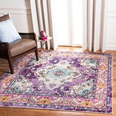 a purple and blue area rug in front of a window with a chair next to it