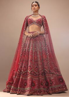 Dark red lehenga with a crop top in royal heritage embroidery.The lehenga comes in multi-color sequins, cut dana, stones, french knots 3D floral motifs embroidery, orange sequins, moti, and cut dana in half circle motifs, green cut dana, and stones in leaf shape motifs embroidery all over in kali design. The whole design is called embossed embroidery. The crop top comes in a plunging scalloped neckline with half sleeves and moti and beads fringes at the hemline. Red Hand Embellished Lehenga With Traditional Drape, Red Hand Embellished Traditional Lehenga, Red Hand Embellished Saree Set, Hand Embellished Red Lehenga For Reception, Red Hand Embellished Anarkali Set, Anarkali Style Red Hand Embellished Choli, Red Hand Embellished Traditional Drape Sets, Bollywood Style Red Hand Embellished Sharara, Festive Red Hand Embellished Lehenga