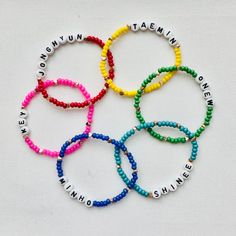 six bracelets with words written on them in different colors and sizes, all made out of plastic beads