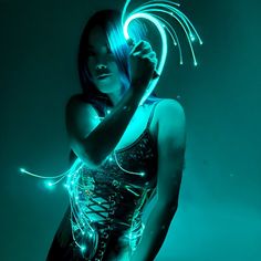 a woman with blue hair and glowing lights