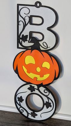 the letter b is decorated like a pumpkin