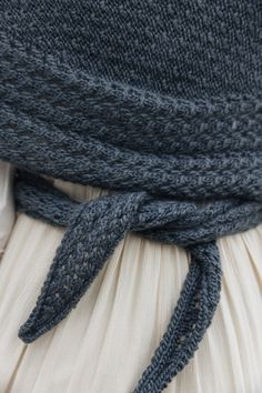 the back of a woman's head wearing a blue and white knitted hat