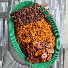 a green plate topped with meat and rice