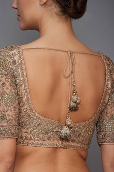 the back of a woman's blouse with an intricate design