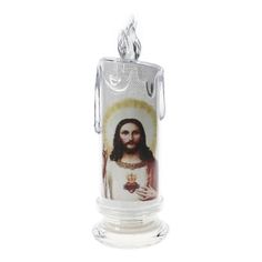 a glass candle holder with jesus holding a heart in it's right hand, on a white background