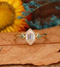 a close up of a ring on top of a leaf