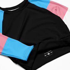 Life's too short for boring clothes and this cheeky crop top with transgender flag sleeves isn't here to play it cool; it's here to turn heads. With a snug fit that screams confidence, it's perfect for those who like to flaunt what they've got with a touch of extra sass. Whether you're strutting at a pride parade, groovin' at a festival, or just living your best life, this transgender crop top is your ticket to fabulousness. Best of all this cropped trans flag top isn't just for show; it's also Stretch Color Block Tops For Streetwear, Fitted Color Block Tops For Streetwear, Pink Fitted Top For Cheerleading, Retro Black Crop Top For Streetwear, Black Stretch Tops For Cheerleading, Black Retro Cropped Top, Black Retro Cropped Crop Top, Retro Black Cropped Top, Casual Crew Neck Crop Top With Color Block