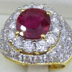 Luxury Ruby Cluster Ring, Luxury Ruby Cluster Ring With Center Stone, Luxury Cluster Ruby Ring With Center Stone, Luxury Ruby Cluster Ring With 17 Jewels, Luxury Ruby Cluster Jewelry, Luxury Ruby Cluster Ring For Formal Occasions, Luxury Ruby Cluster Ring With Gemstones, Luxury Cluster Ruby Ring Gift, Luxury Ruby Rings With Prong Setting