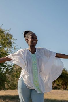 Your search for the perfect flowy top that billows effortlessly in the wind ends here. The Fifi top is the ultimate resort wear for when you're frolicking on the beach or dancing through a sea of people. Featuring tonal stripes and a geometric pattern inspired by Habesha Kemis, the traditional dress of Ethiopian women. Style Details: 100% Cotton Handwash Made in Ethiopia Menby Design Fit Details: One size fits all Ethiopian Women, Habesha Kemis, Flowy Top, Traditional Dress, Flowy Tops, A Sea, Ethiopia, Traditional Dresses, Resort Wear