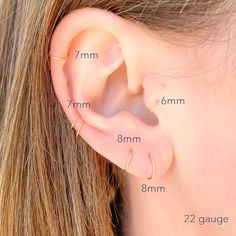 an ear piercing is shown with measurements for the size and shape of each piece in front of