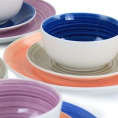 colorful plates and bowls are arranged on top of each other