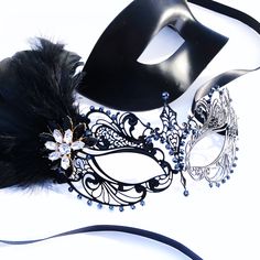 Couples masquerade masks, black feather, women metal mask and Venetian men mask Women black mask studded with black onyx rhinestones that give a hint of metallic shade. This mask has black with feathers with black/gold crystal brooch. Men's mask is a simple black base with a comfortable fit. S H I P P I N G - Processed same day or within 24 hours. 1-2 day guaranteed delivery services offered, add items to cart and click on shipping tab for rates. Please leave a check out note with your need date Black Eye Mask For Masquerade, Adjustable Black Fantasy Mask, Black Eye Mask For Carnival, Black Masquerade Mask For Wedding Carnival, Black Masquerade Mask For Mardi Gras, Black Venetian Masquerade Mask For Carnival, Fantasy Black Mask For Masquerade, Black Masks And Prosthetics For Mardi Gras Masquerade, Elegant Black Masks For Carnival