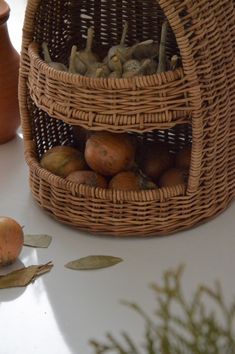 a basket filled with apples sitting on top of a table