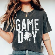 Show your love of the game with this vintage style Game Day Indian mascot design on the popular comfort colors tee. This is a great school spirit shirt for the game and everyday wear! It makes the perfect mom gift or shirt for the coach's wife! This garment-dyed t-shirt is made with 100% ring-spun cotton. The soft-washed, garment-dyed fabric brings extra coziness to your wardrobe while the relaxed fit makes it an excellent daily choice. The double-needle stitching throughout the tee makes it hig Coach Gift Shirts, Coachs Husband Shirt, Cool Coach Shirts, Coaches Wife Shirt, Coaches Wife, Coach Shirts, School Spirit Shirts, Football Mom Shirts, Spirit Shirts