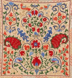 an embroidered cloth with red, blue and green flowers