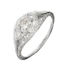 an antique style diamond ring with filigrees