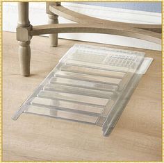 a clear plastic tray sitting on top of a wooden floor